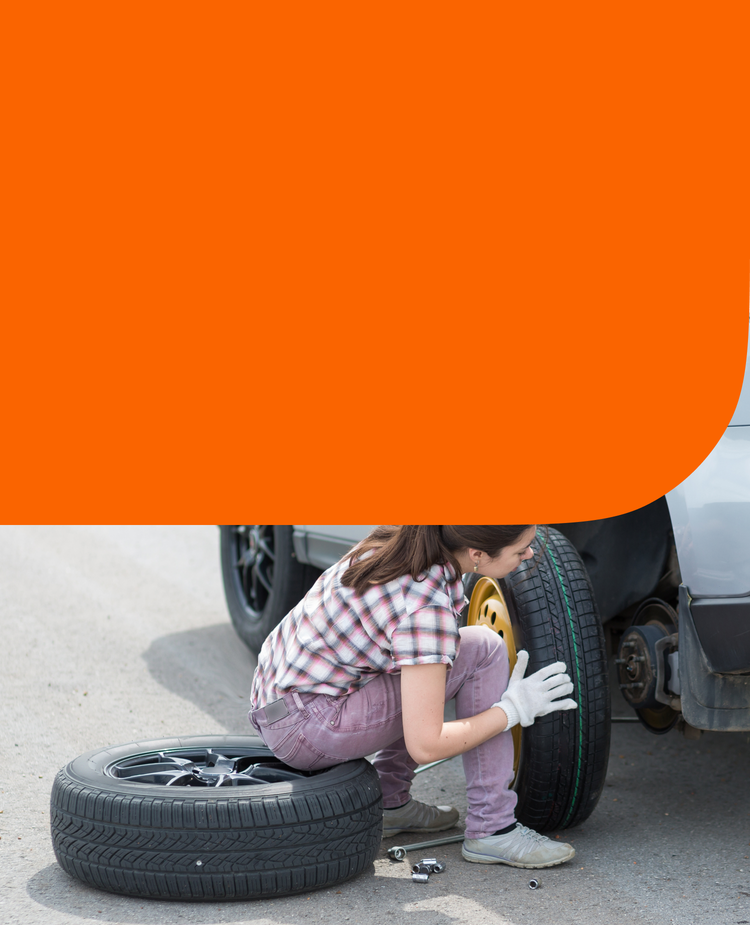 A woman changing a tire
