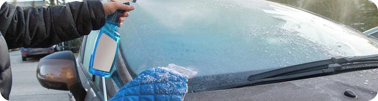 person scraping frozen windshield