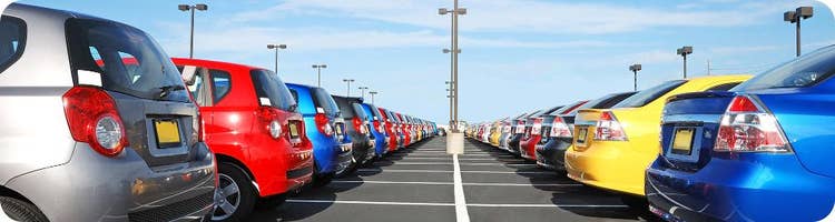 many cars parked in dealership lot