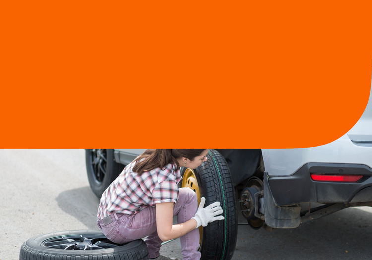 A woman changing a tire
