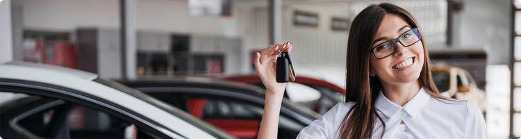 car buyer with multiple repossessions holding keys to car