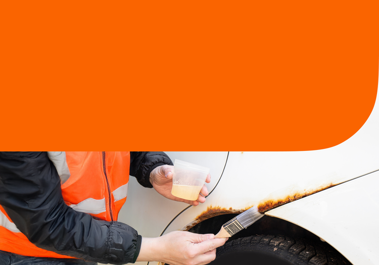 A man fixing rust on his car