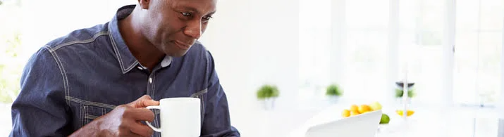 Man searching online for a place to buy a new car