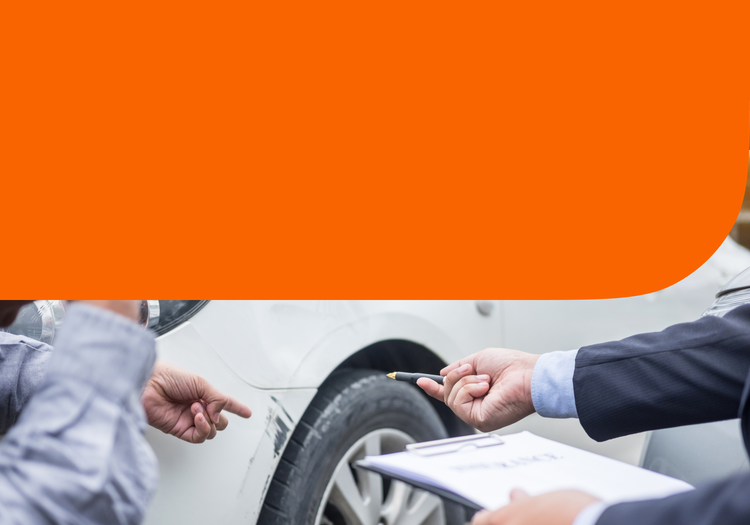 Two people inspect car damaage.
