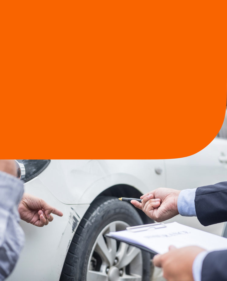 Two people inspect car damaage.