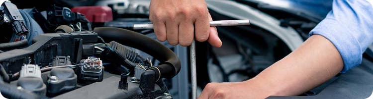 close up of man performing vehicle maintenance