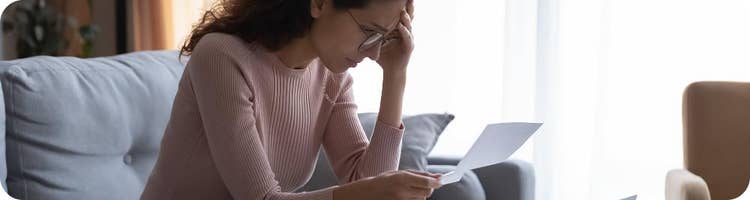 woman at home worries over paperwork