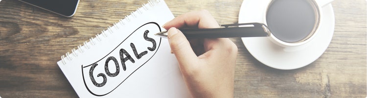 Person writing down financial goals