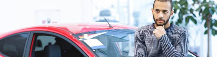 man wondering about car he stands next to