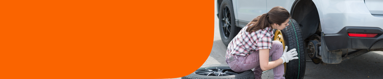 A woman changing a tire